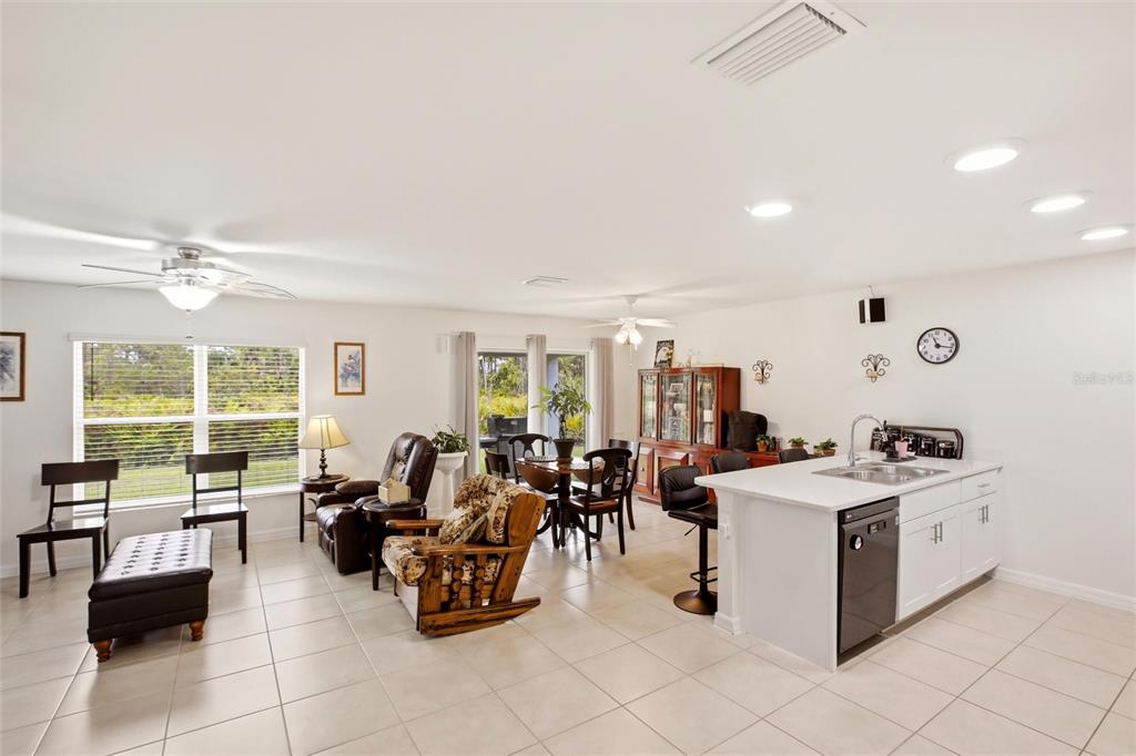 An aerial view shows a single-story house with a paved driveway and surrounding wooded area — 3215 SORREL STREET, PORT CHARLOTTE, FL