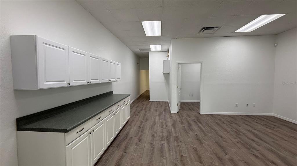 An office space features white cabinets, a dark countertop, and wood-look flooring — 20101 PEACHLAND BOULEVARD, PORT CHARLOTTE, FL