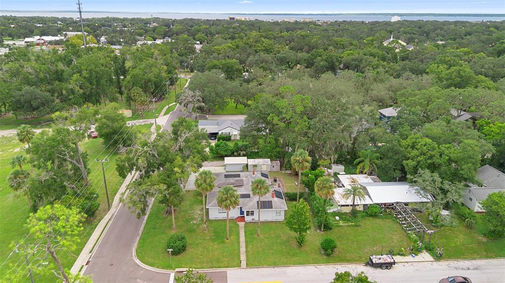 An aerial view of a single-story house with a white exterior and a metal roof — 232 W 17TH STREET, SANFORD, FL