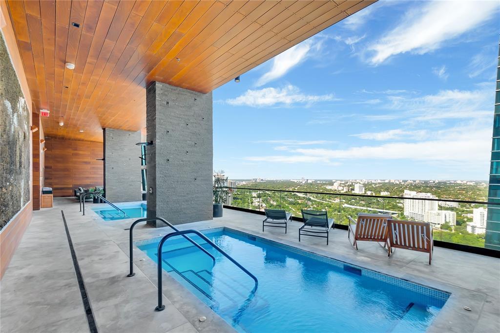 An outdoor terrace features two swimming pools, lounge chairs, and a view of the city — 1451 Brickell Avenue # 1202, Miami FL 33131, MIAMI, FL