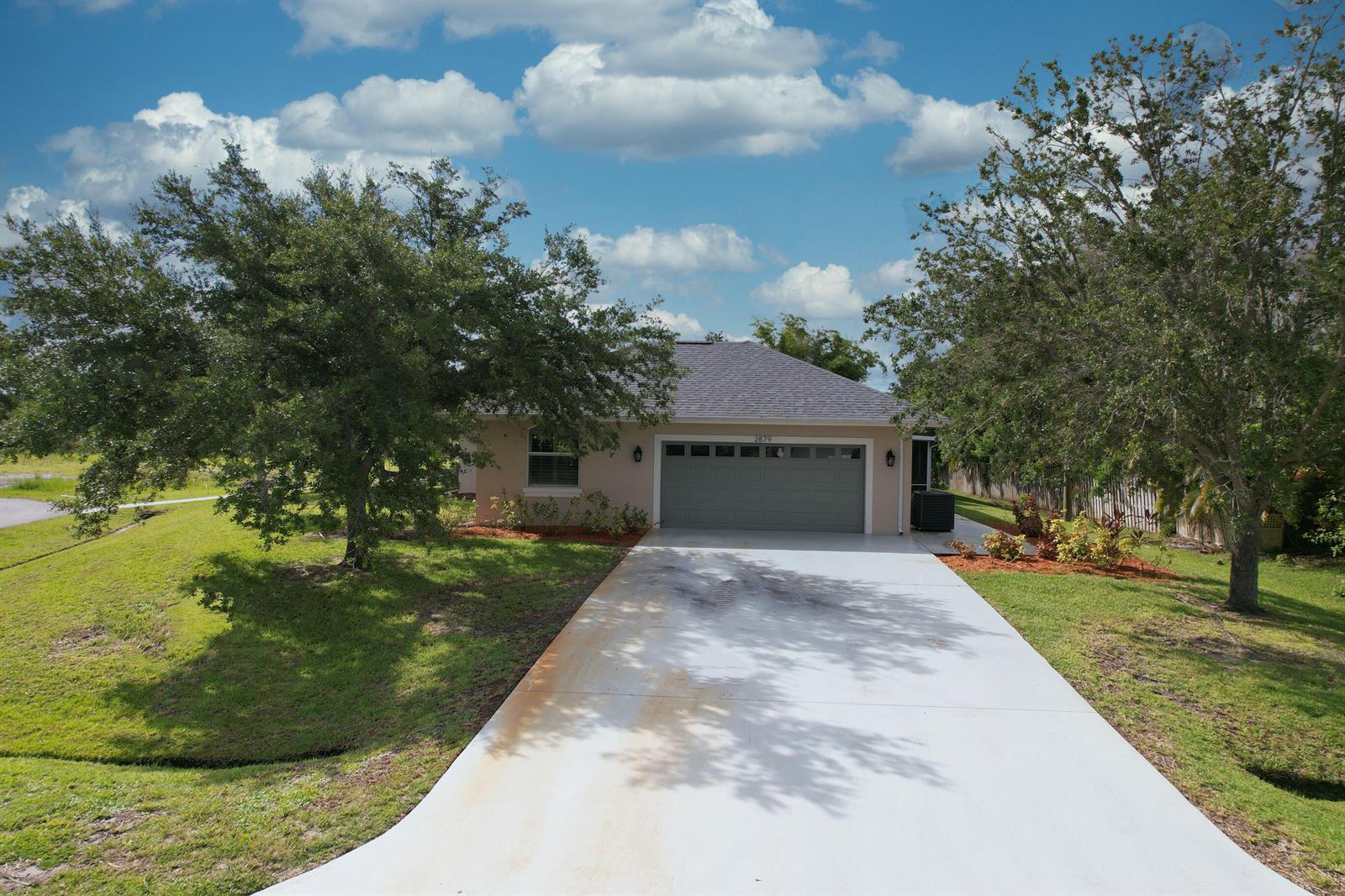 A kitchen with light wood cabinets, a large central island, and stainless steel appliances — 2879 SE Peru Street, FL 34984, FL