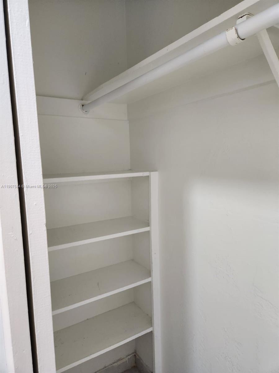A closet features a white hanging rod and several built-in white shelves — 8101 SW 73rd Ave # 30, Miami FL 33143, MIAMI, FL