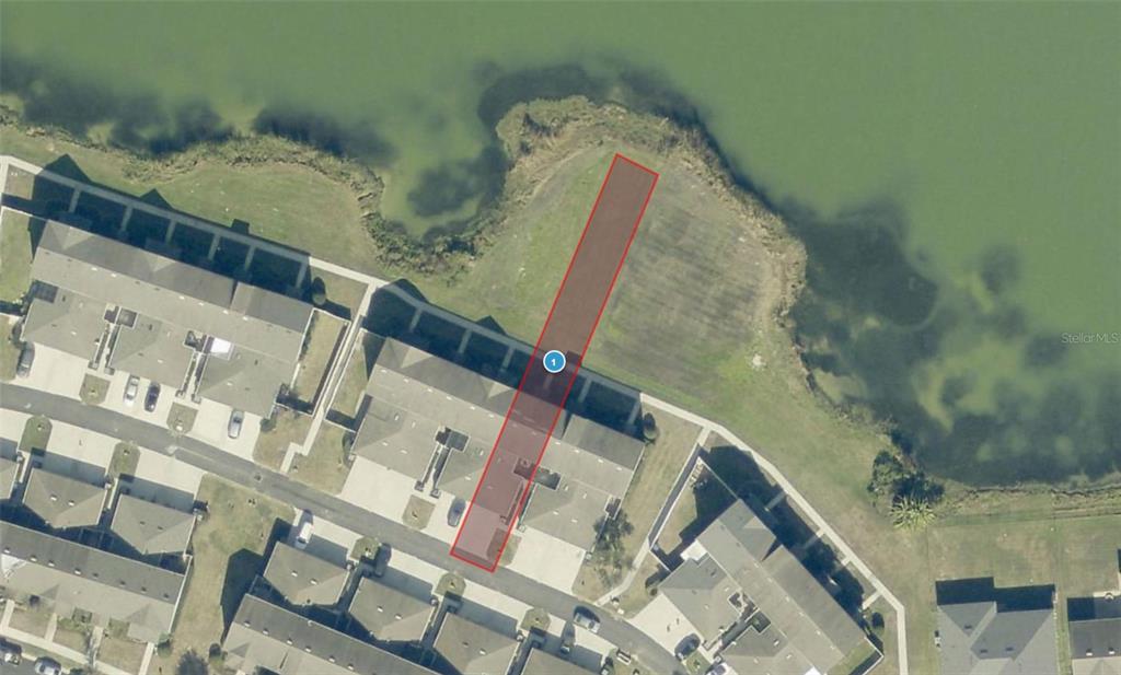 An aerial view shows a highlighted rectangular parcel of land extending to a lake — 513 JUNIPER SPRINGS DRIVE, GROVELAND, FL