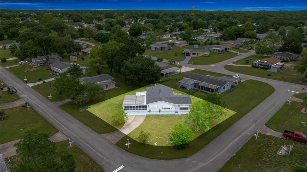 An aerial view shows a single-story house with a screened porch on a corner lot — 9230 SW 101ST LANE, OCALA, FL