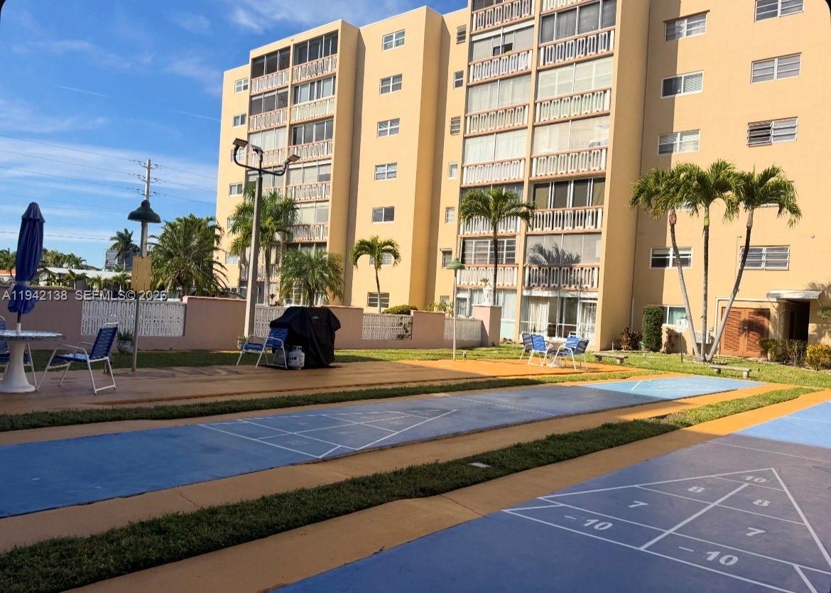 An outdoor shuffleboard court sits in front of a multi-story apartment building — 420 NE 12th Ave # 502, Hallandale Beach FL 33009, HALLANDALE BEACH, FL