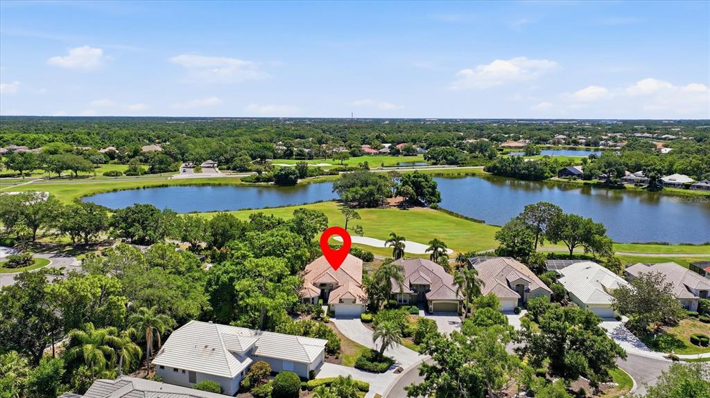 An aerial view shows a house with a red location pin near a golf course — 8009 HAMPTON COURT, UNIVERSITY PARK, FL