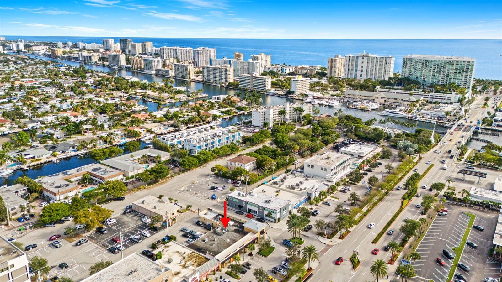 An aerial view shows a commercial building with a red arrow pointing to its roof — 2667 E Atlantic Boulevard, Pompano Beach FL 33062, POMPANO BEACH, FL