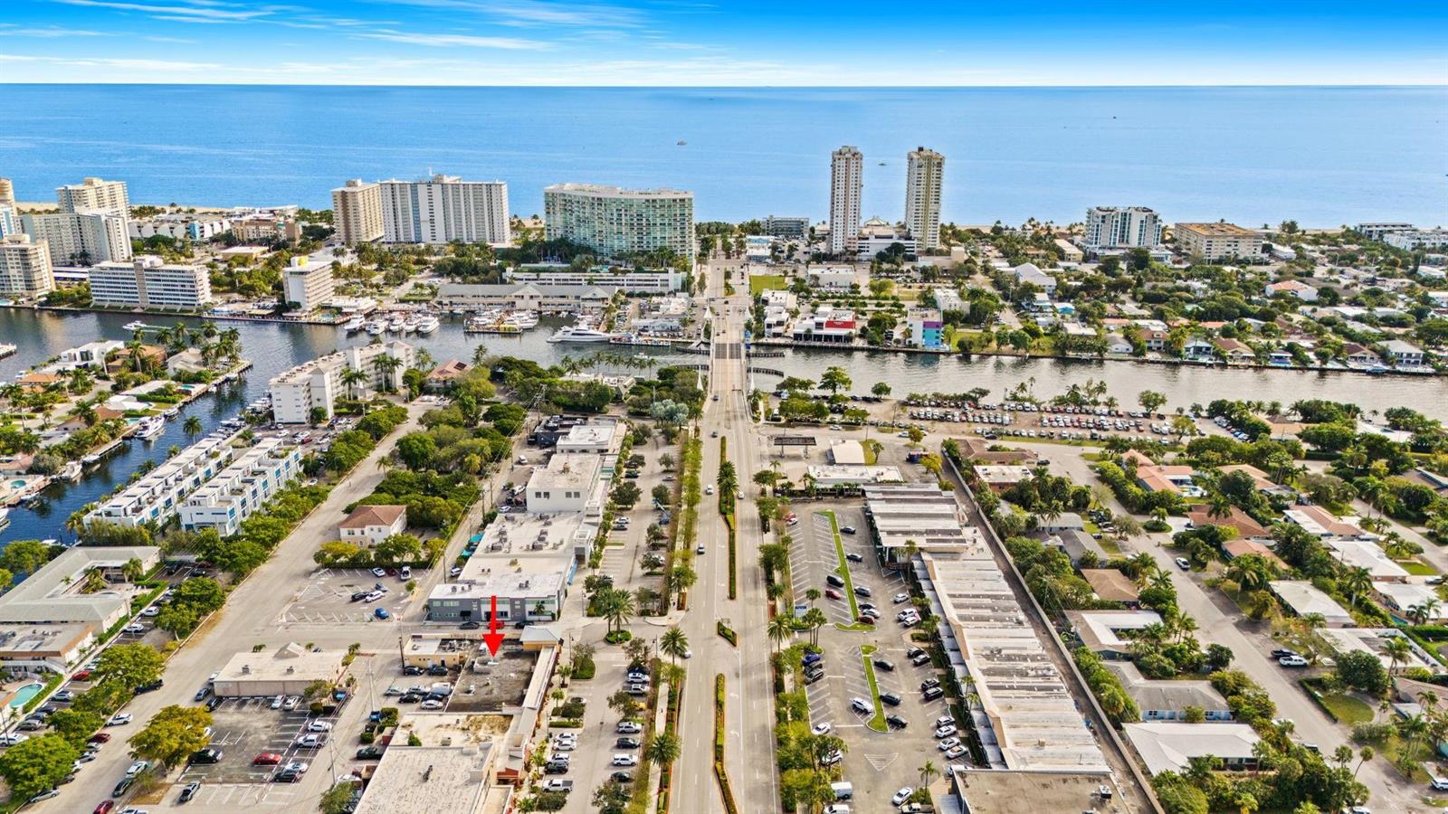 An aerial view shows a commercial building with a red arrow pointing to its roof — 2667 E Atlantic Boulevard, Pompano Beach FL 33062, POMPANO BEACH, FL
