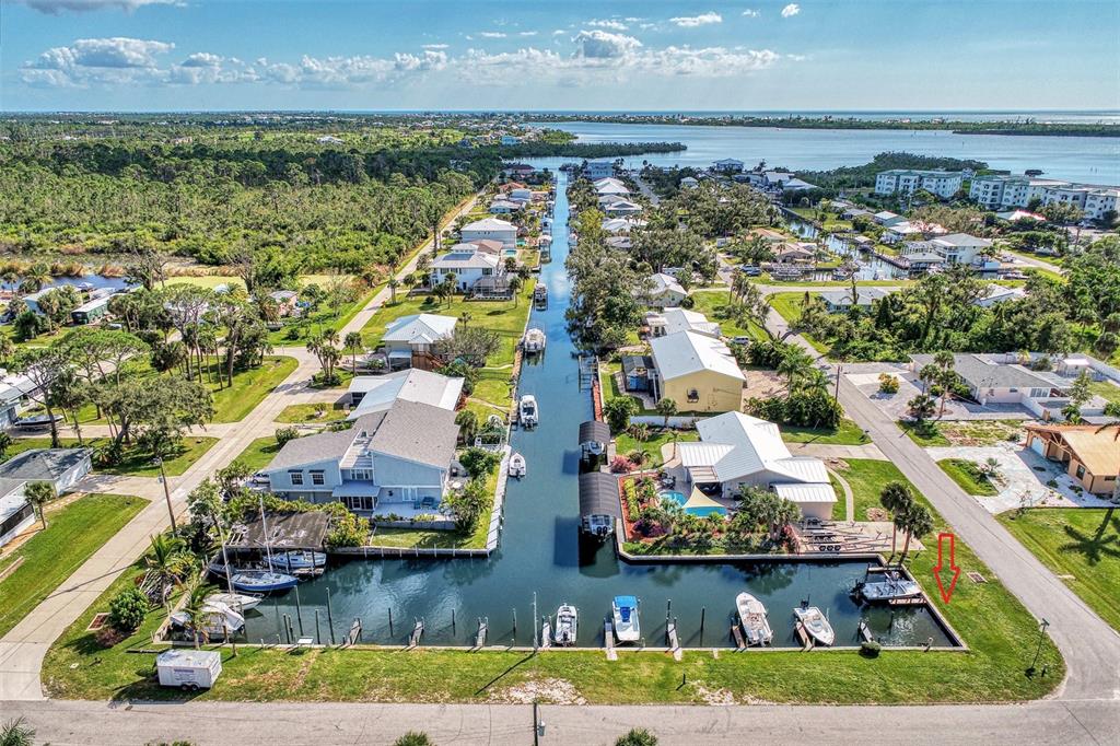 An aerial view shows waterfront houses along a canal with private boat slips and docks — 8225 ROBERT STREET, ENGLEWOOD, FL