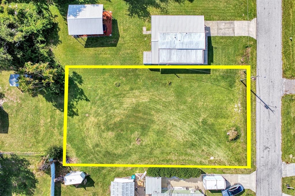 An aerial view shows a rectangular, grass-covered vacant lot outlined in yellow — 8225 ROBERT STREET, ENGLEWOOD, FL