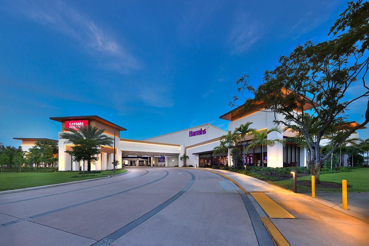 The exterior of a modern Harrah's casino building features a curved driveway and palm trees — 575 Oaks Lane # 1002, Pompano Beach FL 33069, POMPANO BEACH, FL