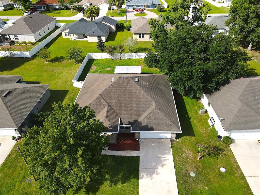 An aerial view shows a suburban house with a dark shingled roof and driveway — 70 PHEASANT DRIVE, PALM COAST, FL