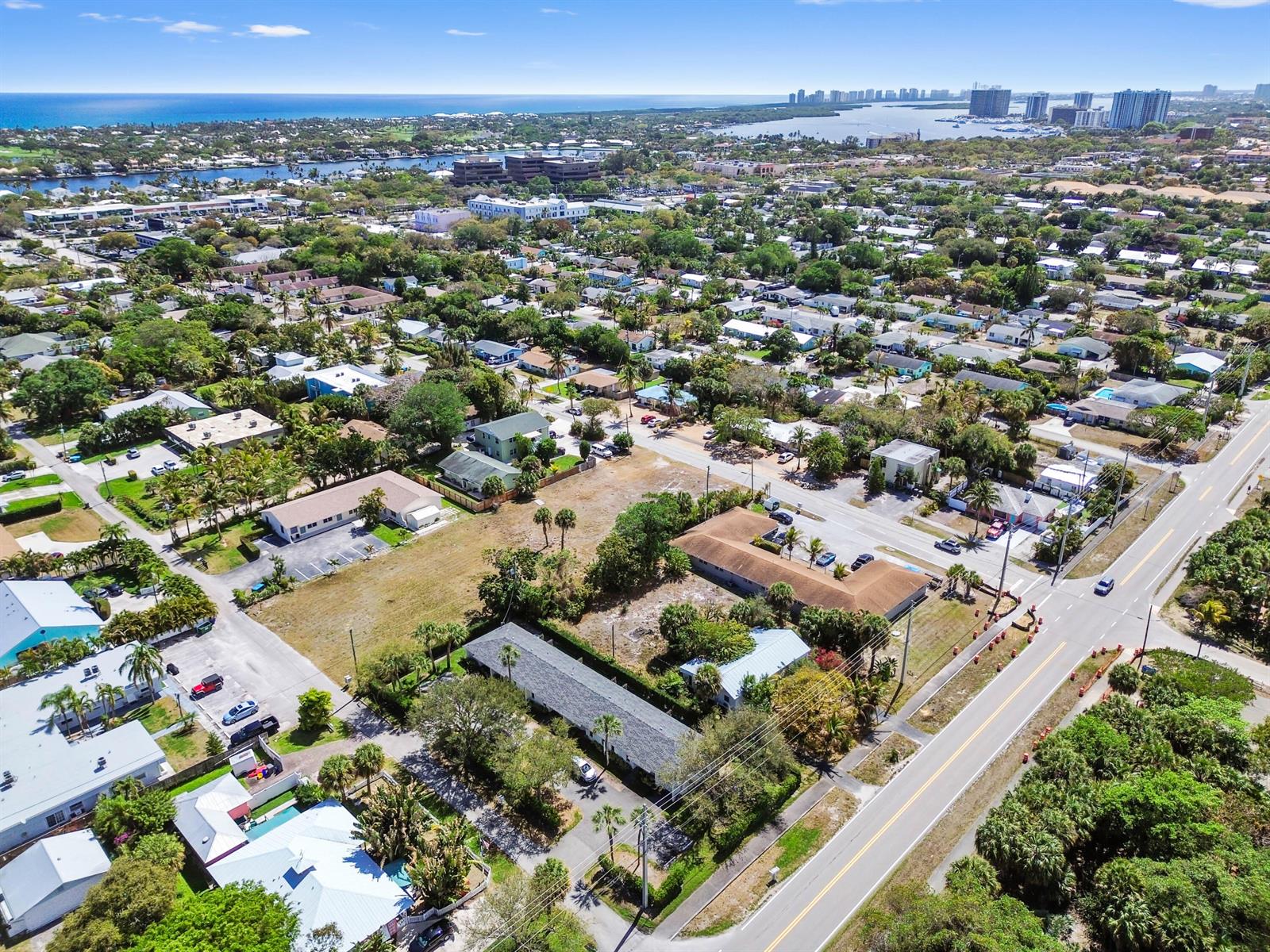 An aerial view shows a residential neighborhood with several low-rise buildings and vacant lots — 1955 Juno Road, North Palm Beach FL 33408, NORTH PALM BEACH, FL
