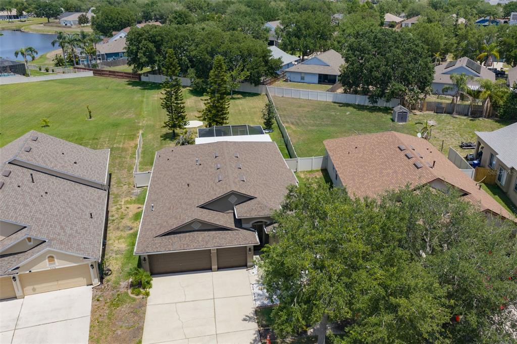 An aerial view shows a suburban house with a two-car garage and a backyard pool — 7318 GUILFORD PINE LANE, APOLLO BEACH, FL