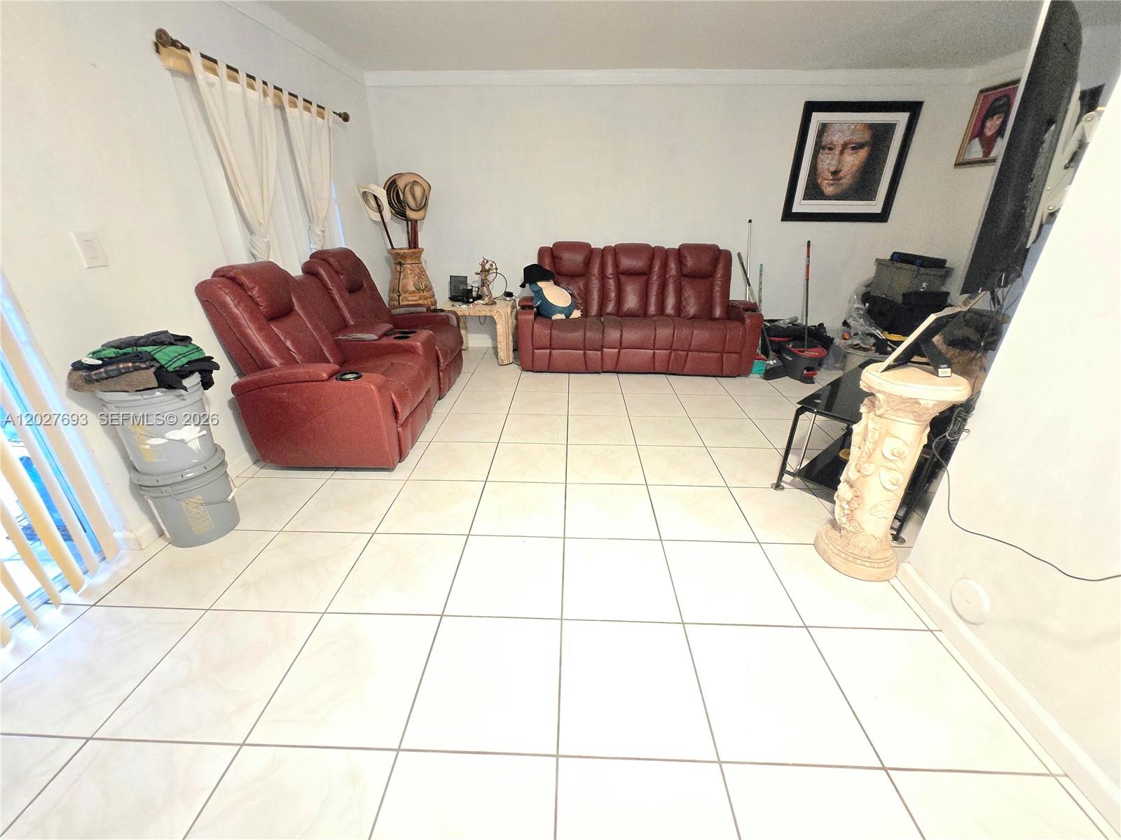 A living room features white tile floors, red leather seating, and a framed portrait — 7255 NW 173rd Dr # 8, Hialeah FL 33015, HIALEAH, FL