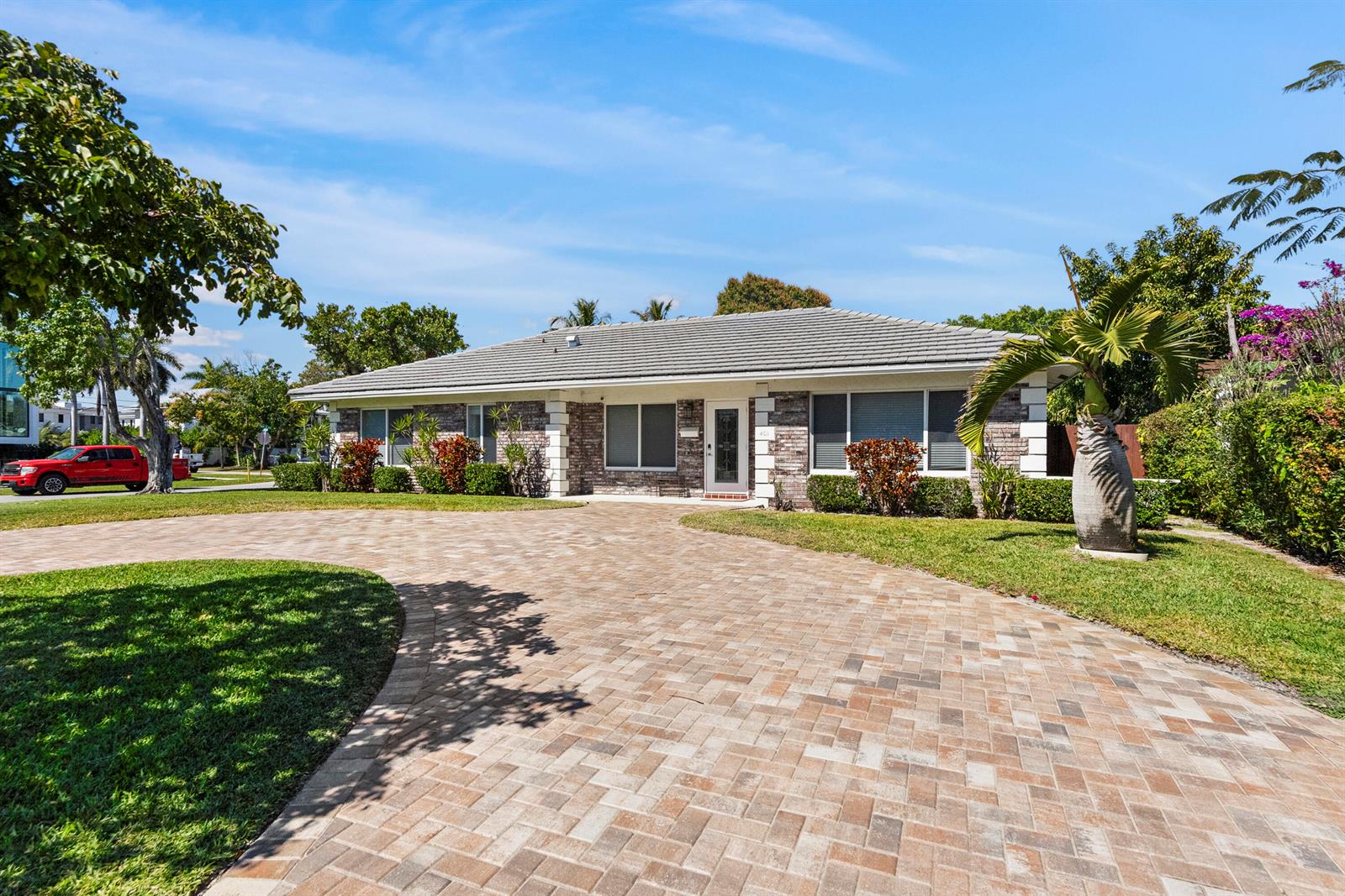 A single-story brick house with a paved driveway and a palm tree in the front yard — 401 NE 10th Terrace, Boca Raton FL 33432, BOCA RATON, FL