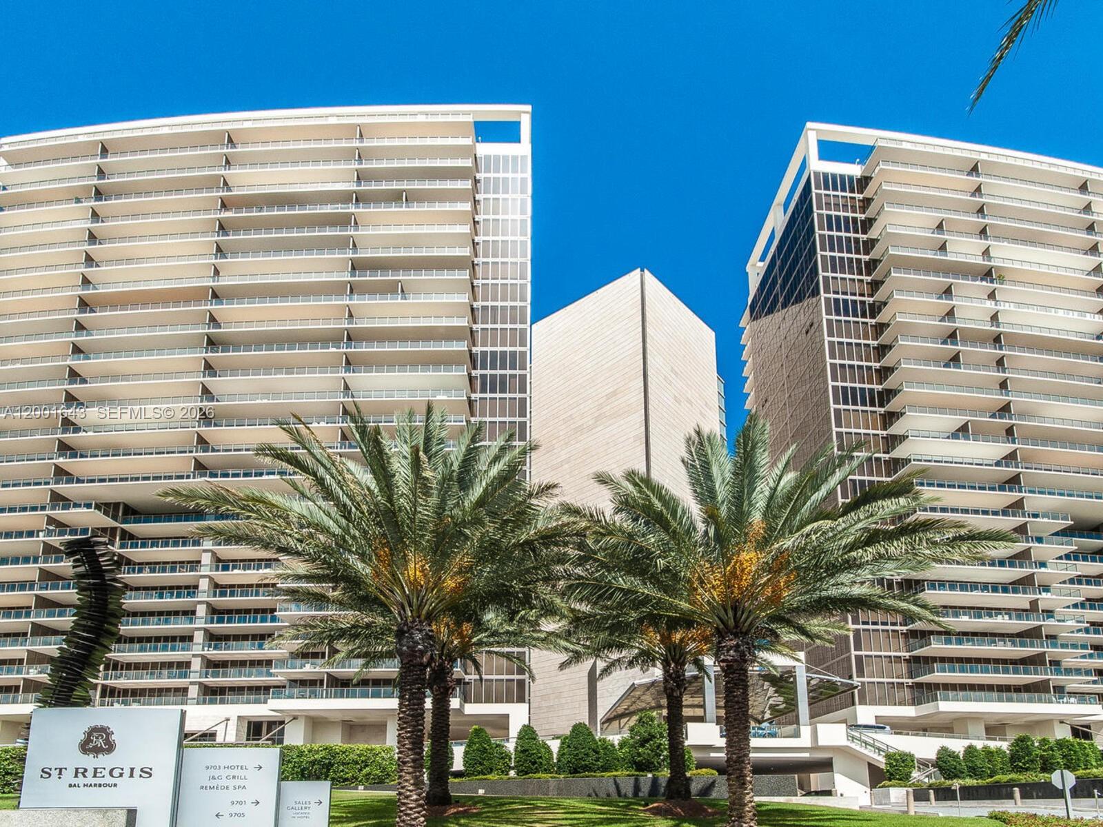 Two tall, modern residential towers stand behind palm trees under a clear blue sky — 9705 Collins Ave # 804N, Bal Harbour FL 33154, BAL HARBOUR, FL