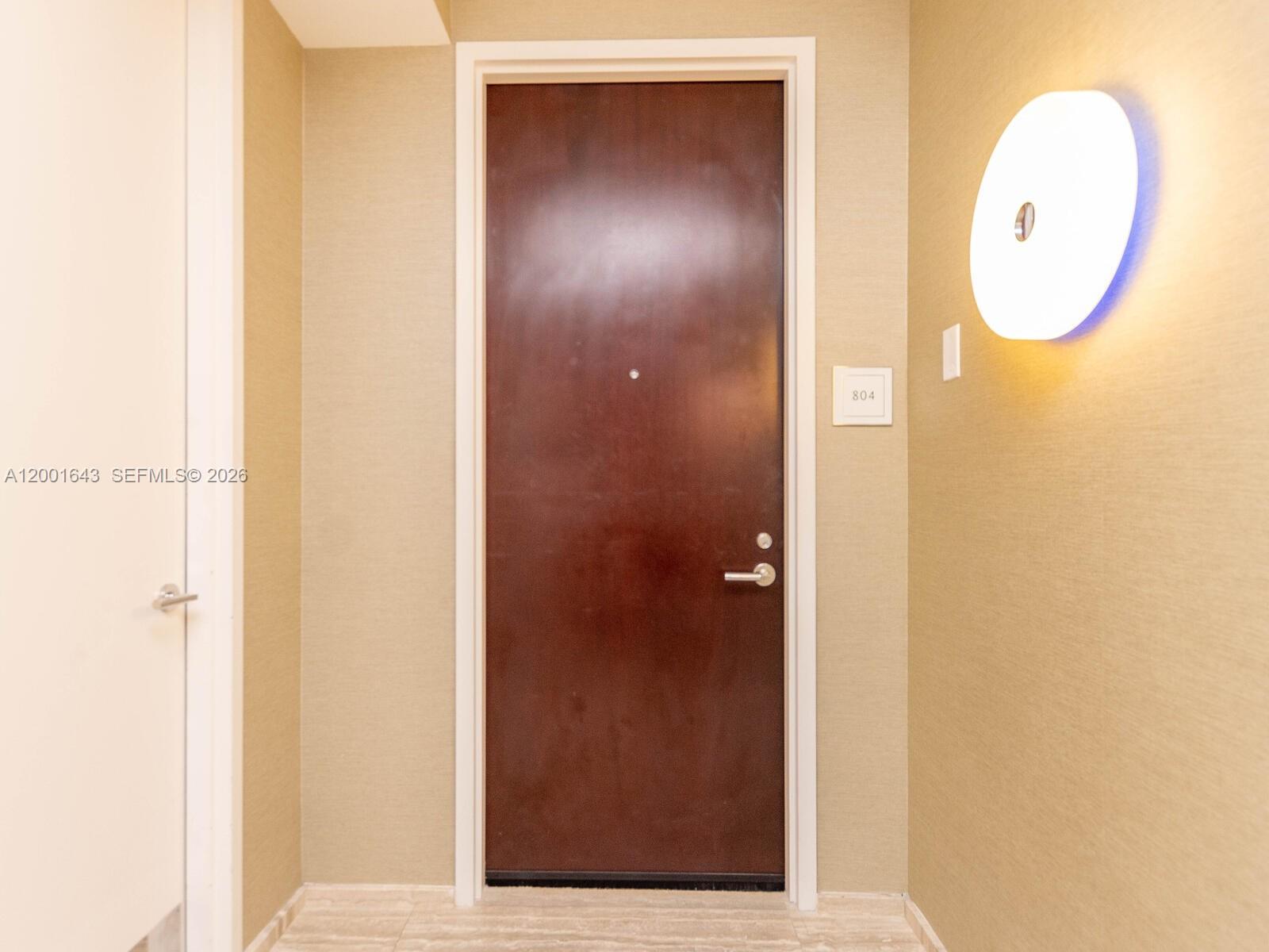A dark wooden door with a room number sign is centered in a hallway — 9705 Collins Ave # 804N, Bal Harbour FL 33154, BAL HARBOUR, FL