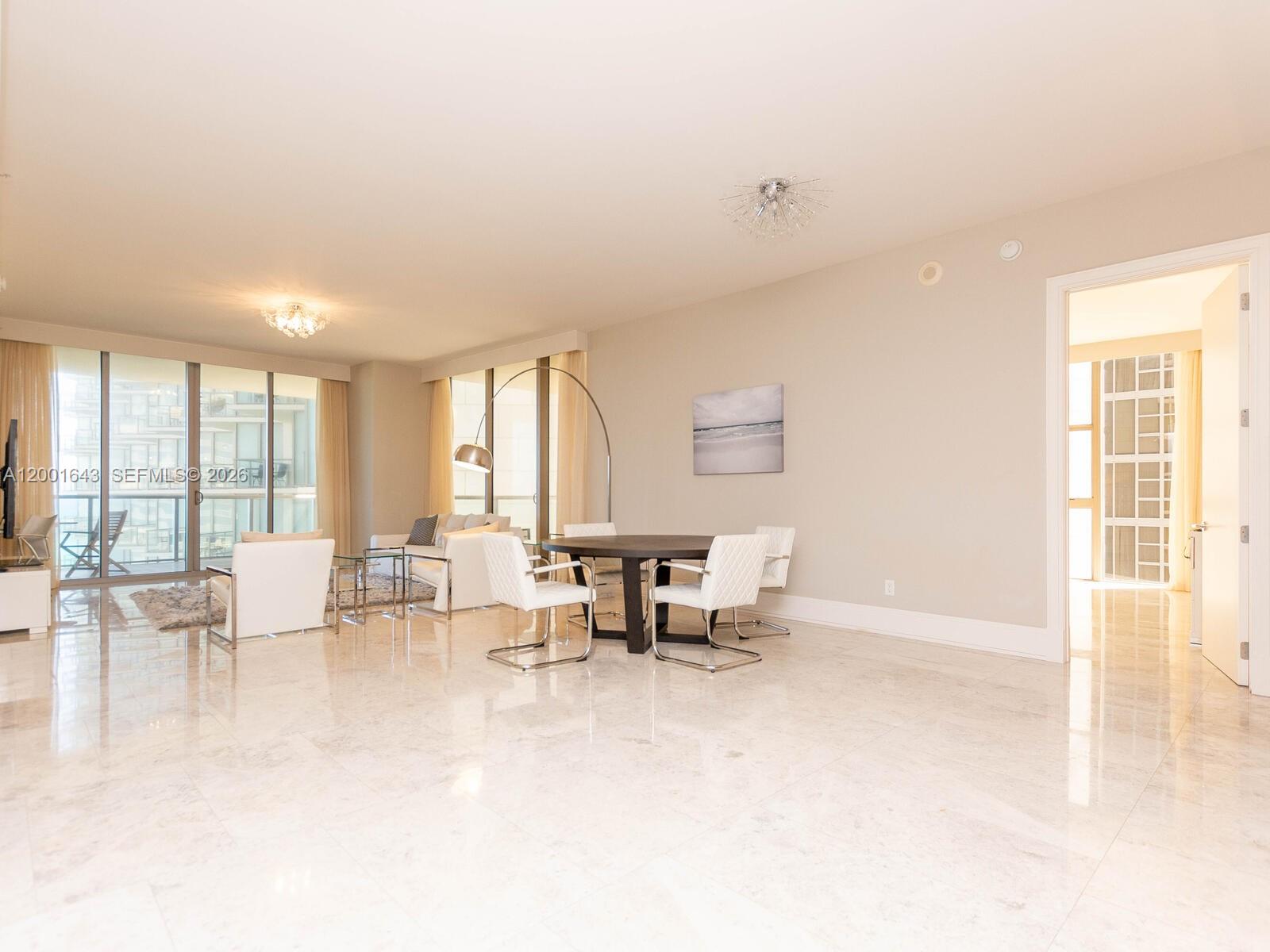A bright, open-concept living and dining area features white tile floors and floor-to-ceiling windows — 9705 Collins Ave # 804N, Bal Harbour FL 33154, BAL HARBOUR, FL