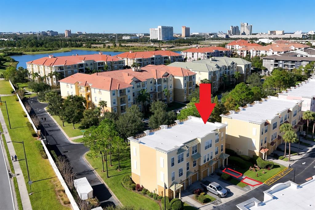 An aerial view shows a multi-story townhouse complex with a red arrow pointing toward one unit — 4800 TIDECREST AVENUE UNIT 172, ORLANDO, FL