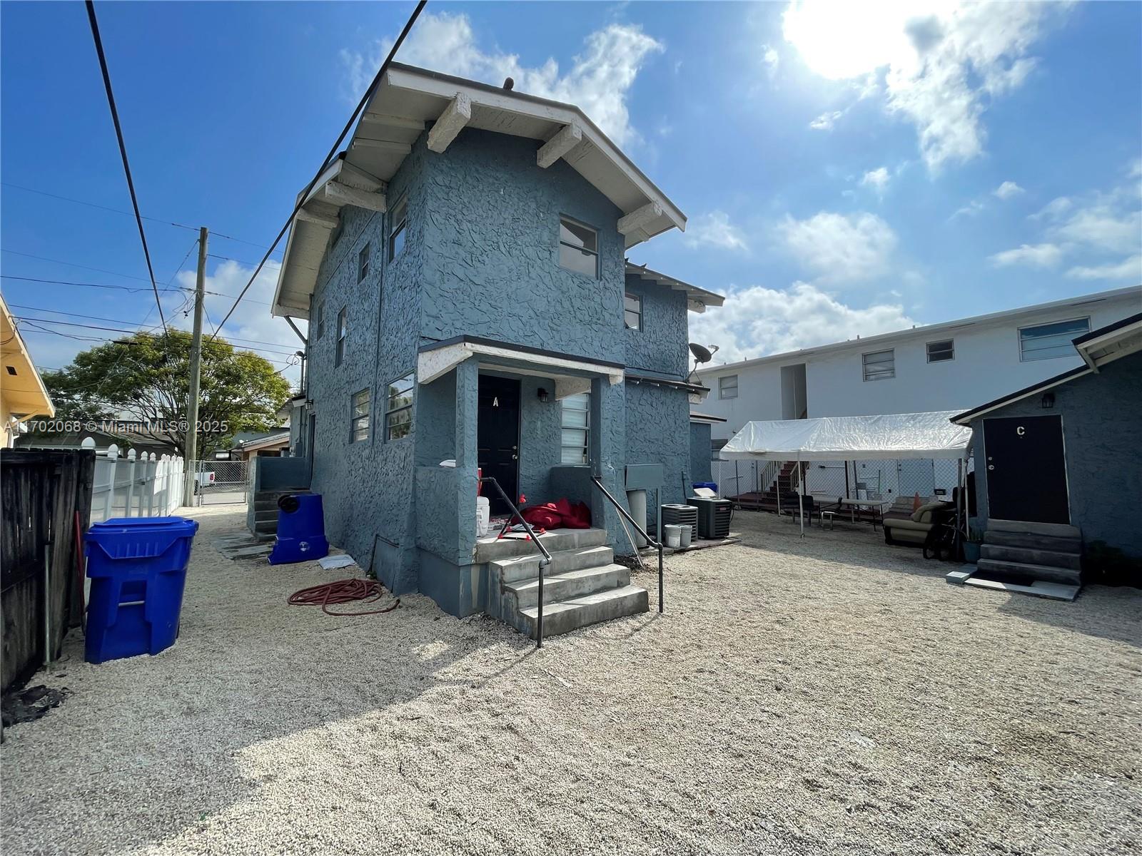 A blue two-story house with a gravel yard and a white canopy structure — 236 SW 10 Avenue, Miami FL 33130, MIAMI, FL