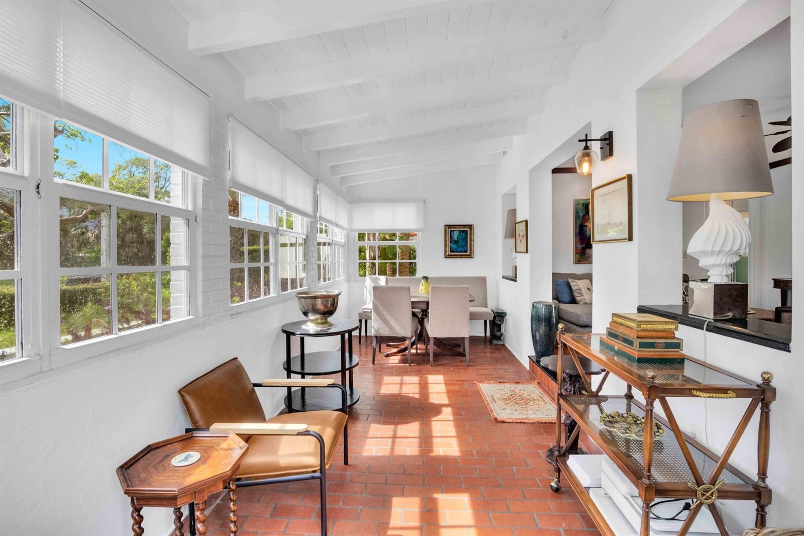 A sunroom features red brick flooring, white beamed ceilings, and a dining area — 1219 N Lakeside Drive, FL 33460, FL