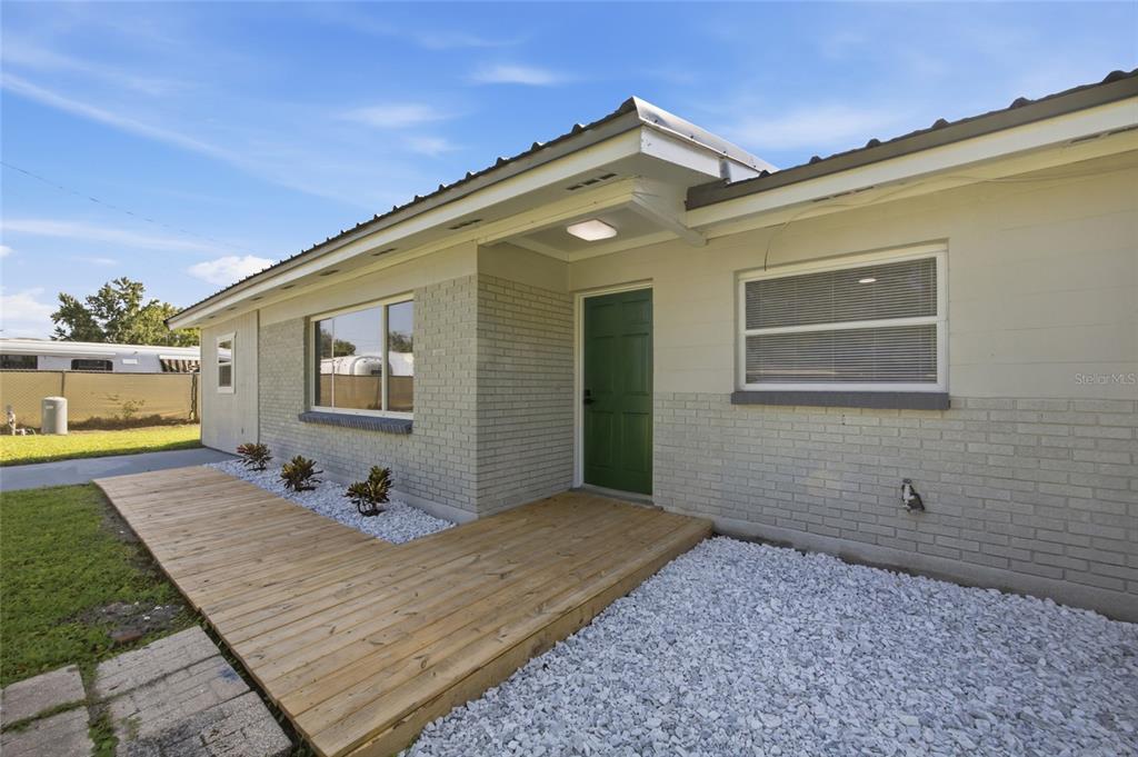 A single-story house with a gray exterior, metal roof, and a concrete driveway — 3502 LILES LANE, PLANT CITY, FL