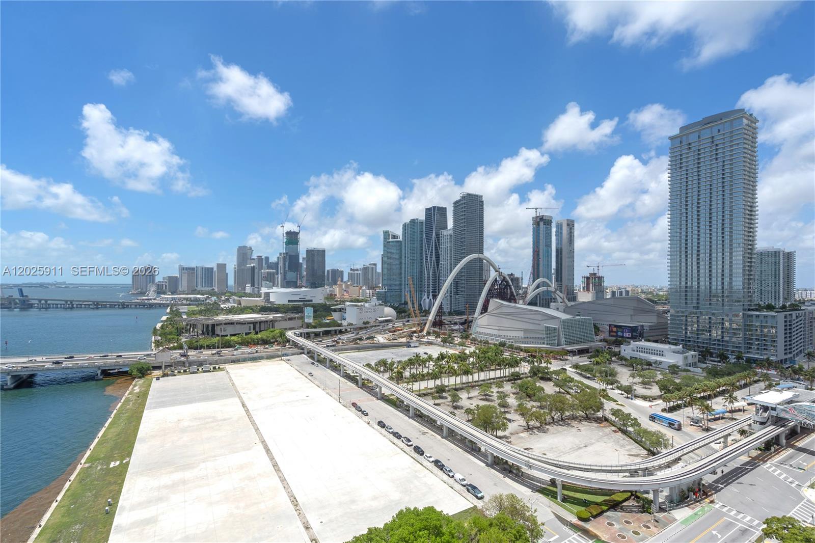 An elevated view of the Miami skyline featuring skyscrapers, a bridge, and a monorail track — 555 NE 15th St # 23I, Miami FL 33132, MIAMI, FL