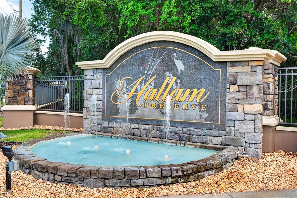 A stone monument sign for Hallam Preserve features a fountain in front of it — 6420 EVERGREEN PARK DRIVE, LAKELAND, FL
