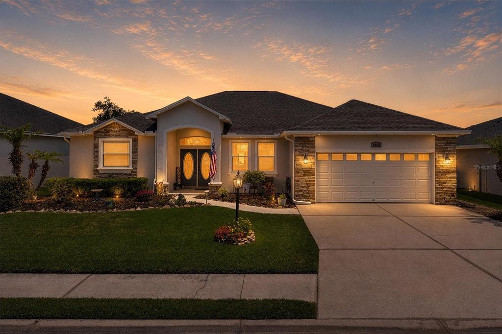 A single-story house with a stone facade, a two-car garage, and a landscaped front yard — 6420 EVERGREEN PARK DRIVE, LAKELAND, FL