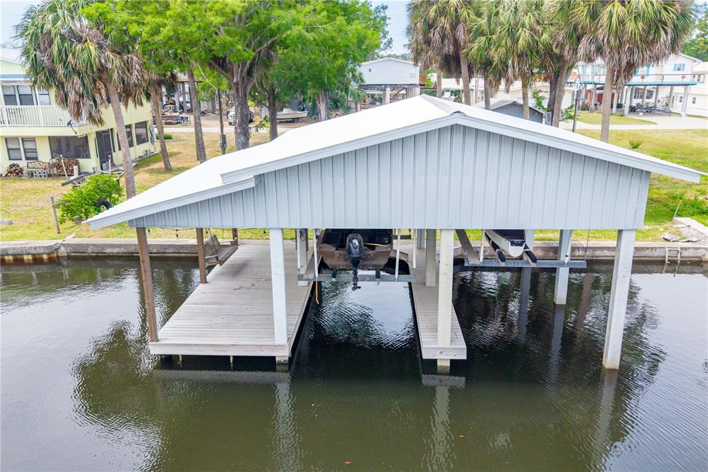 An aerial view of a covered boat dock with two slips on a canal — 75 NE 236TH STREET, SUWANNEE, FL