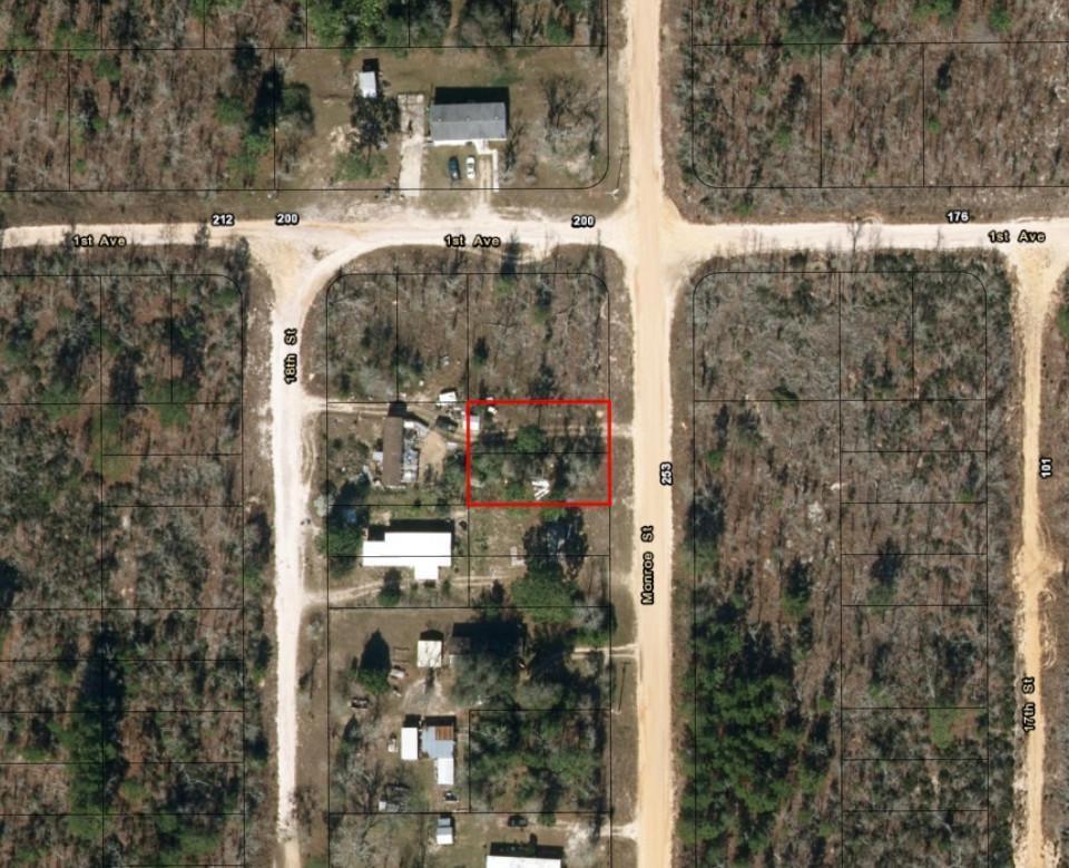 This is an aerial map showing a rectangular lot outlined in red near a street intersection — 0 Monroe Street, FL 32148, FL