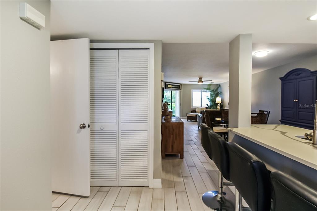 A view from a kitchen counter looking toward a living area with tiled floors — 1313 SIESTA BAYSIDE DRIVE UNIT 1313-D, SARASOTA, FL