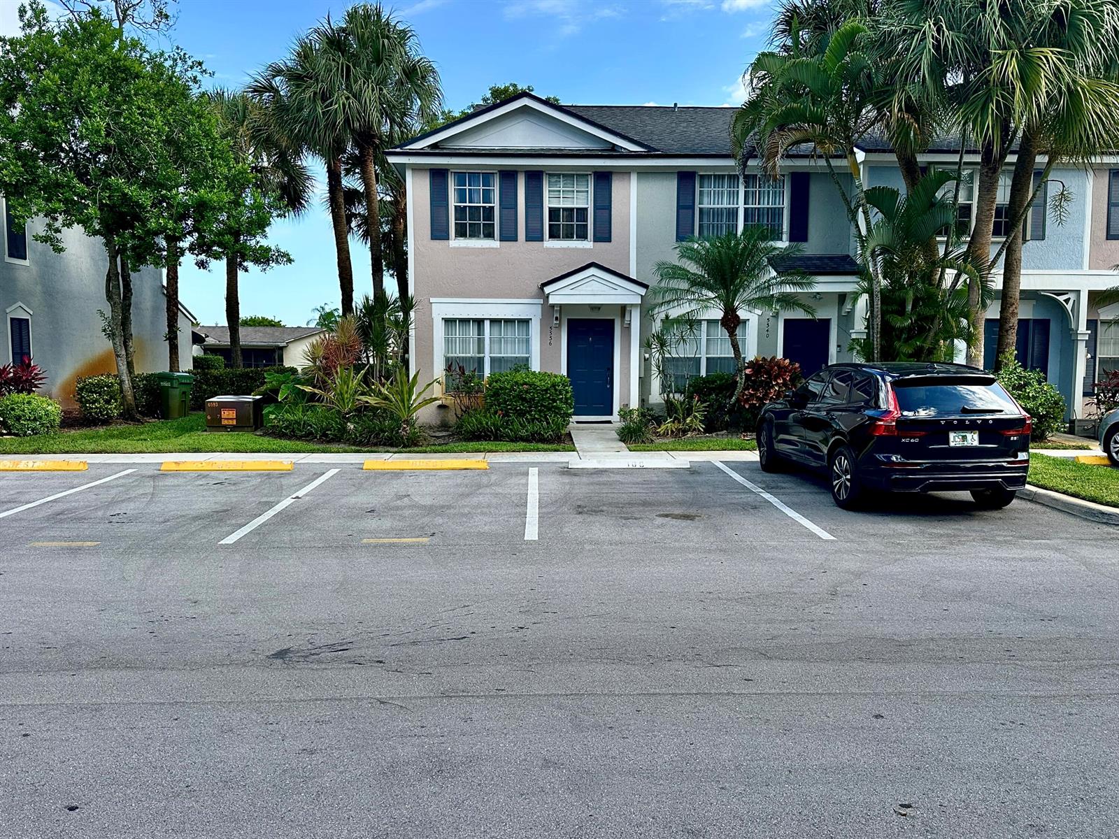 A two-story townhouse with a dark blue front door and a parked black SUV — 5336 Jubilee Way # 189, Margate FL 33063, MARGATE, FL