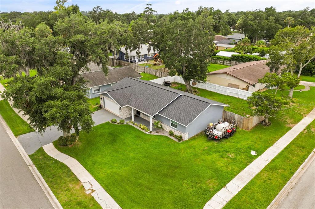 An aerial view of a single-story house with a gray roof and a large lawn — 5780 DEVON STREET, PORT ORANGE, FL