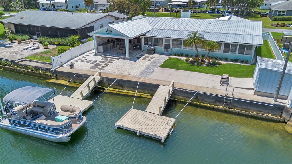 An aerial view of a waterfront home with a boat dock and covered patio area — 1409 SE 4TH AVENUE, CRYSTAL RIVER, FL