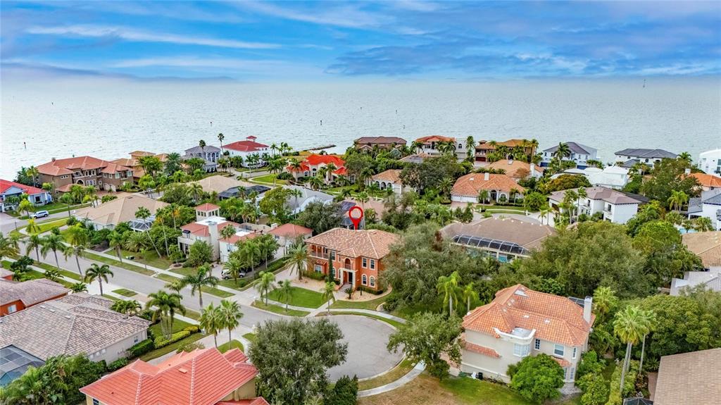 An aerial view shows a residential neighborhood with large houses near a body of water — 5910 LA ROSA LANE, APOLLO BEACH, FL