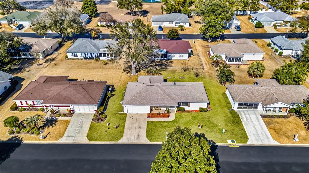 An aerial view shows several single-story suburban houses with driveways and lawns — 11335 SW 138TH LANE, DUNNELLON, FL