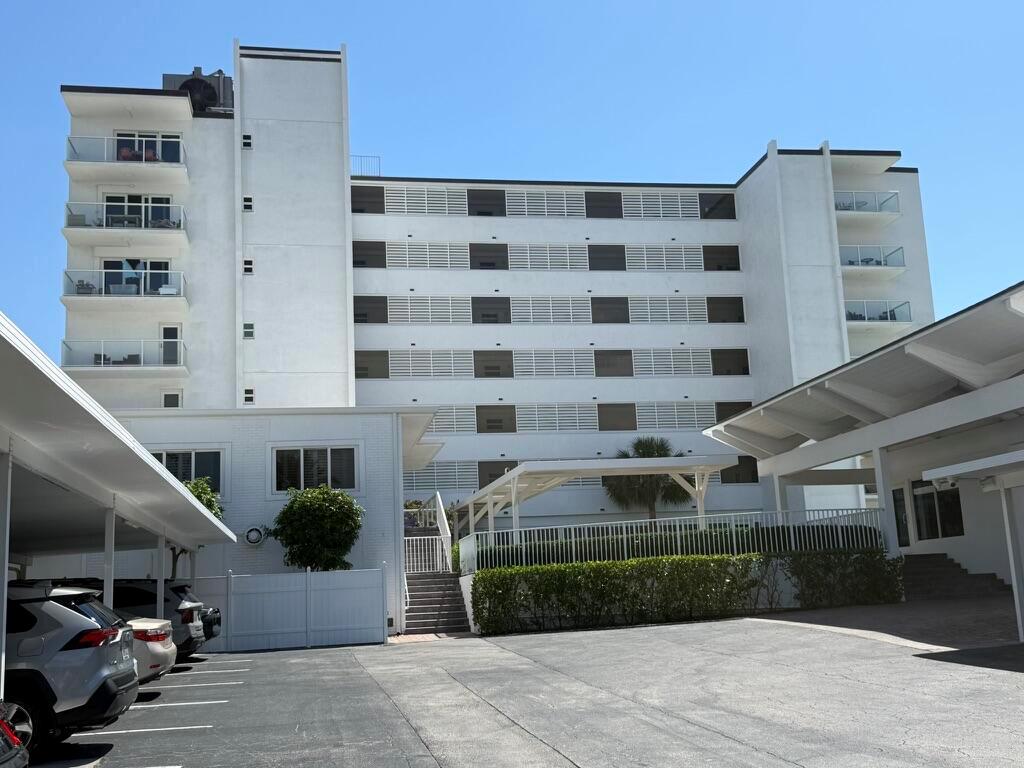 A multi-story white apartment building with balconies and a parking lot in the foreground — 2909 S Ocean Boulevard # 6a, Highland Beach FL 33487, HIGHLAND BEACH, FL