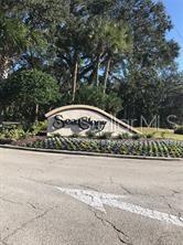 A curved stone monument sign for Sea Stony sits in front of trees and landscaping — 50 NANTUCKET DRIVE, PALM COAST, FL