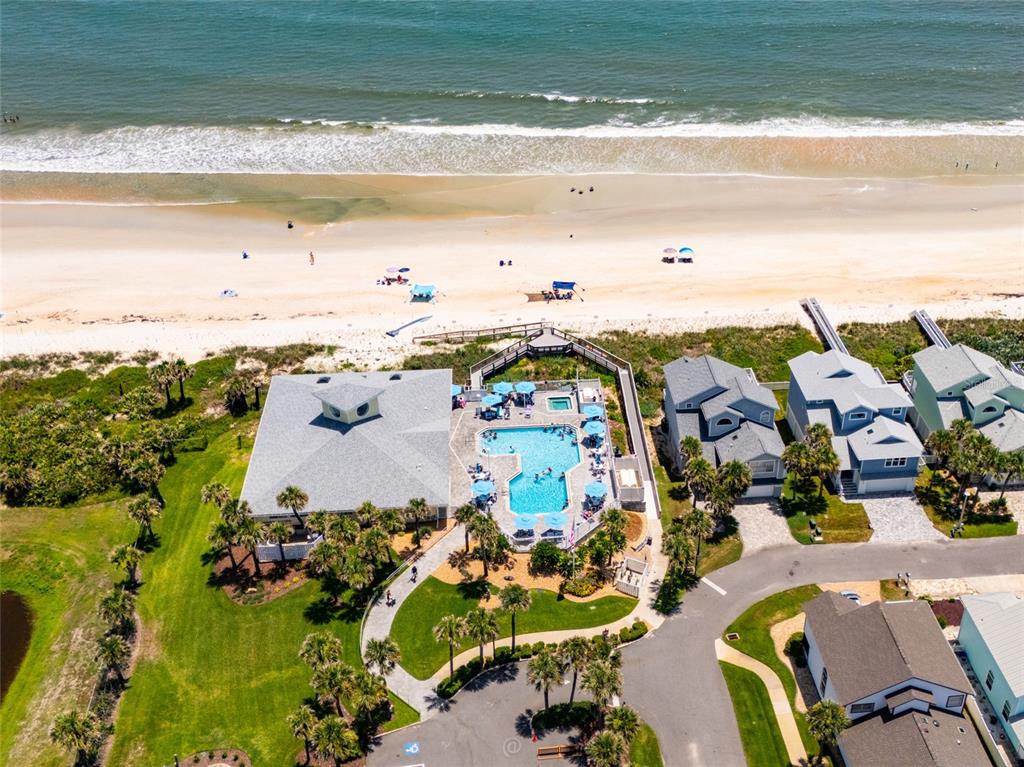 An aerial view shows a beach house with a swimming pool near the ocean — 50 NANTUCKET DRIVE, PALM COAST, FL