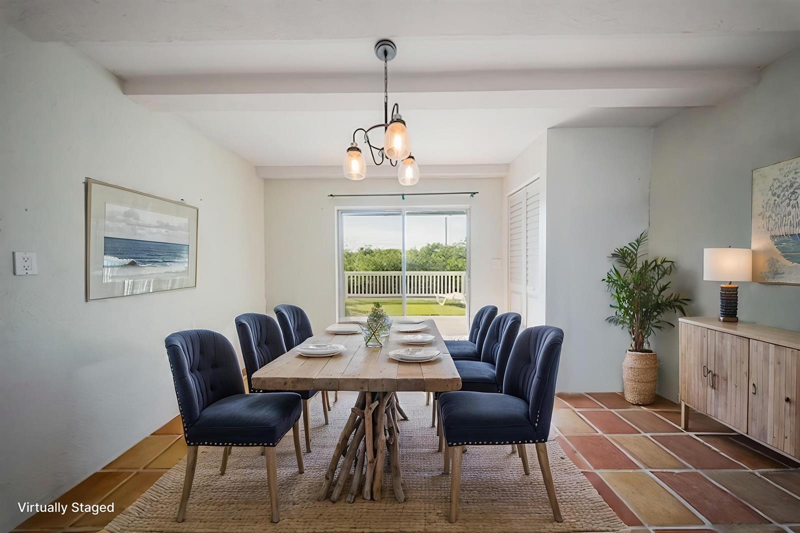 A dining room with a wooden table, blue chairs, and a sliding door to a deck — 133 Valois Boulevard, Key Largo FL 33037, KEY LARGO, FL