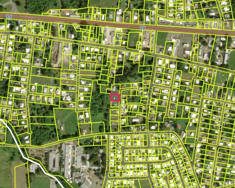 This is a satellite map showing a highlighted property lot within a residential neighborhood — CARR 662 KM 2.1,  SANTANA, PR 00612, ARECIBO, PR