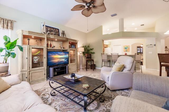 A living room features a large entertainment center, a coffee table, and a recliner — 23238 Marsh Landing Boulevard, FL 33928, FL
