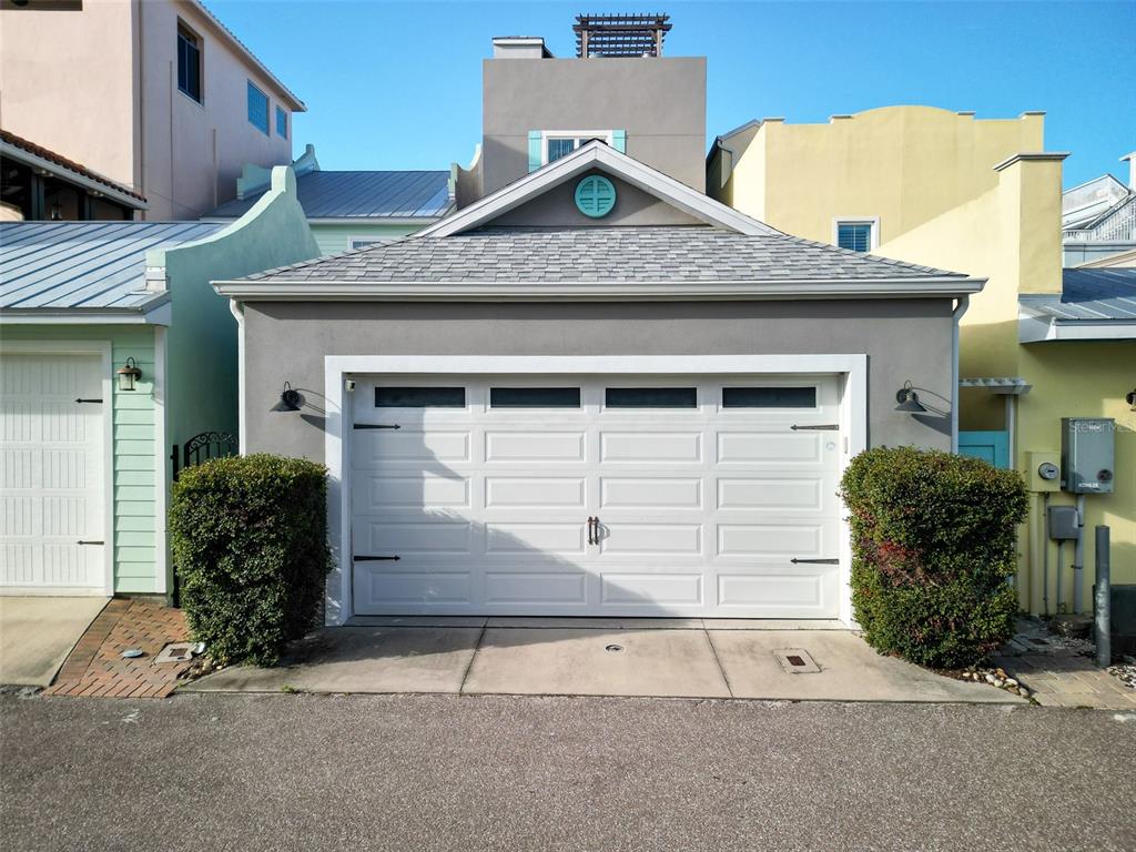 A gray detached garage with a white door and a circular window above — 119 FAULKNER STREET, NEW SMYRNA BEACH, FL