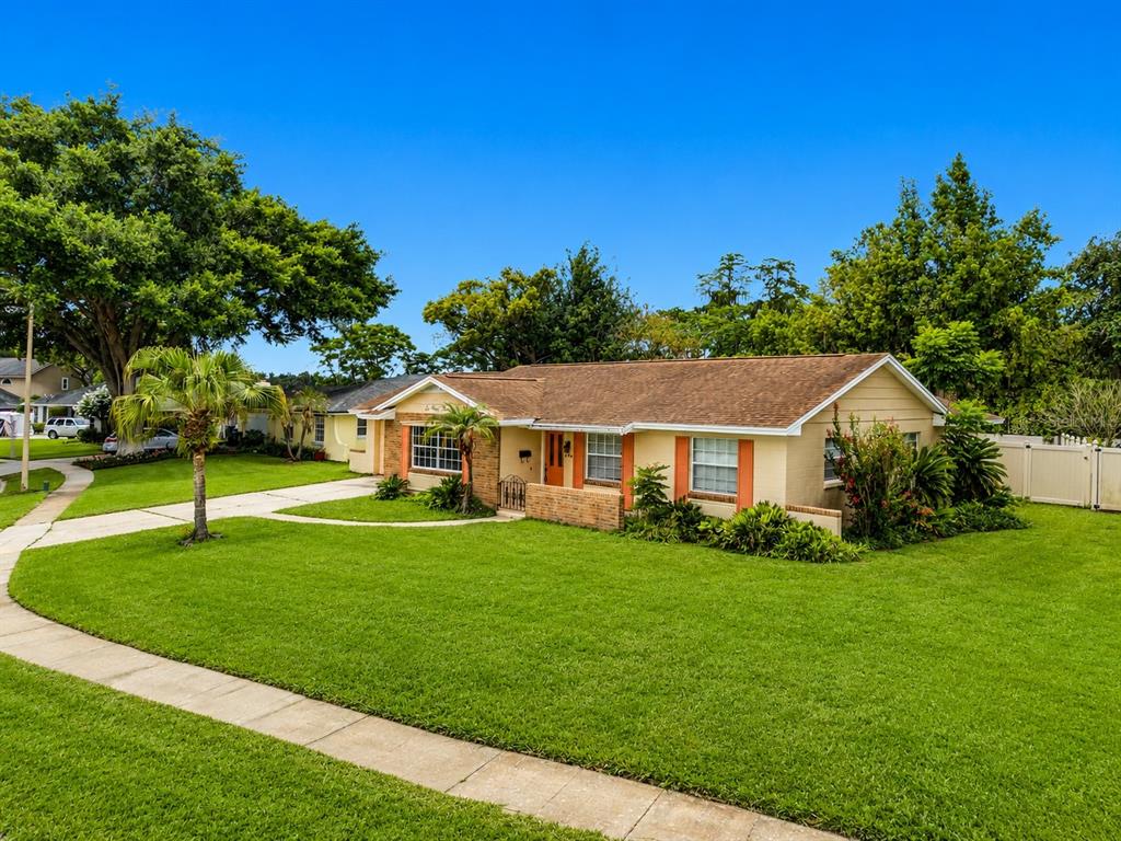 A single-story house with a tan brick facade, brown roof, and a large green lawn — 644 VISCAYA AVENUE, ORLANDO, FL