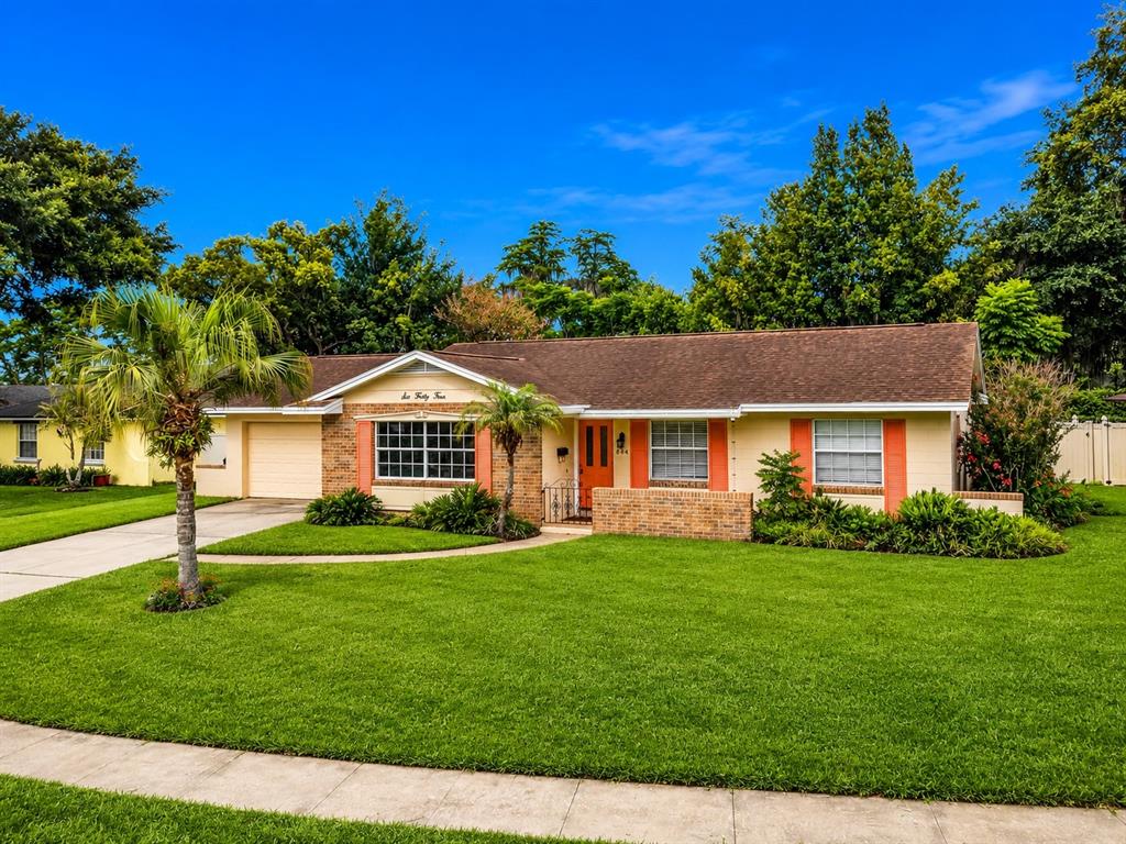 A single-story house with a brick facade, orange trim, and a manicured lawn — 644 VISCAYA AVENUE, ORLANDO, FL