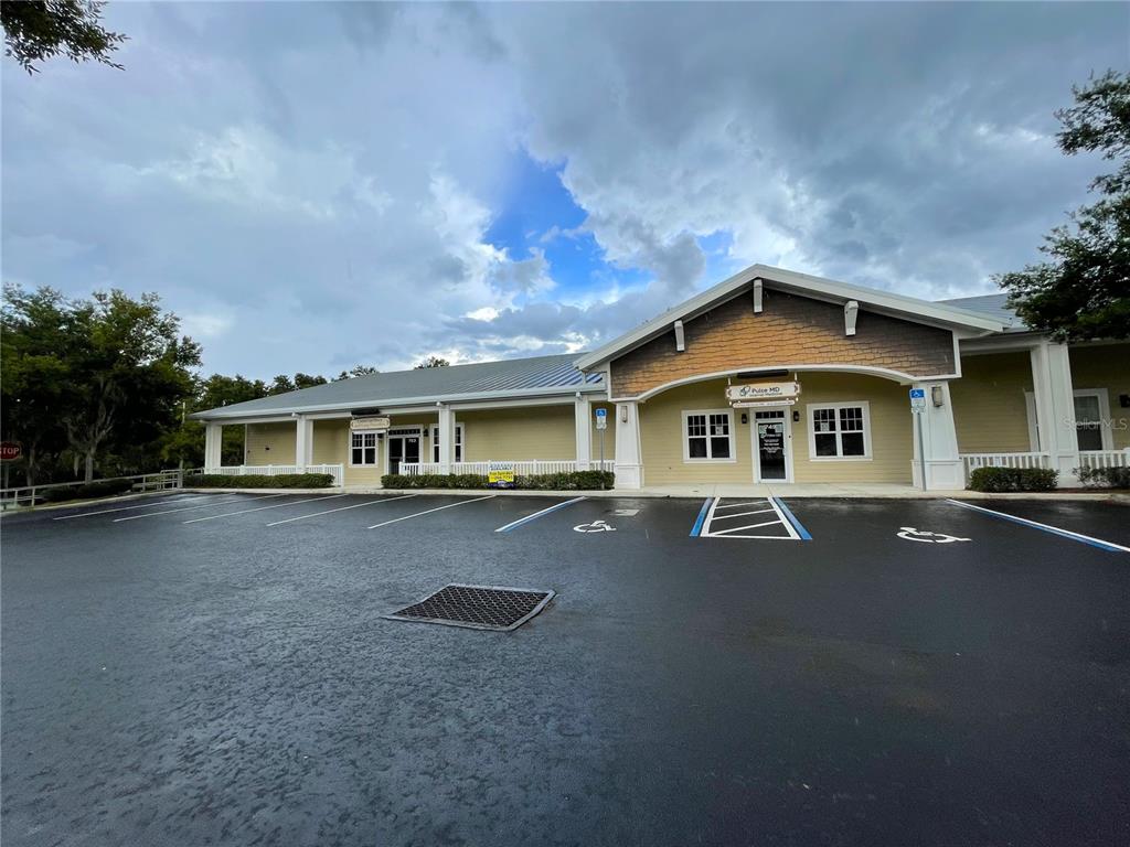A single-story commercial building with a parking lot and handicap-accessible spaces in front — 749 COUNTY ROAD 466, LADY LAKE, FL