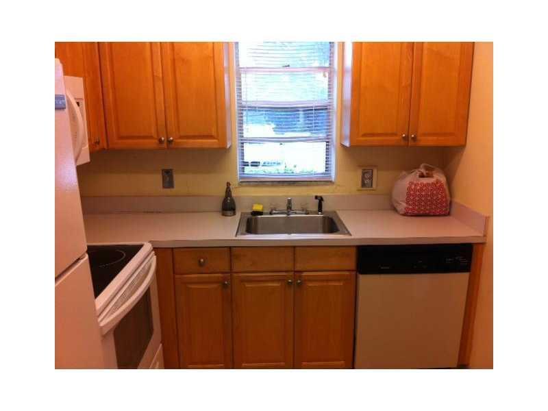 A kitchen features light wood cabinets, a stainless steel sink, and a black dishwasher — 4165 SW 67th Avenue # 107b, Davie FL 33314, DAVIE, FL