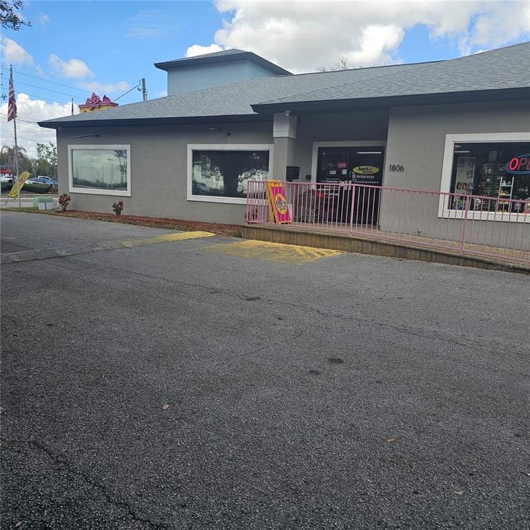 A gray commercial building with a pink railing and an entrance marked 1806 — 1806 1ST STREET S UNIT 1, WINTER HAVEN, FL